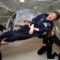 Fisikawan terkemuka Stephen Hawking (tengah) menikmati gravitasi nol selama penerbangan dengan pesawat Boeing 727 yang dimodifikasi milik Zero Gravity Corp. (Zero G). Hawking, yang menderita amyotrophic lateral sclerosis (juga dikenal sebagai penyakit Lou Gehrig) sedang diputar di udara oleh (kanan) Peter Diamandis, pendiri Zero G Corp., dan (kiri) Byron Lichtenberg, mantan spesialis muatan pesawat ulang-alik dan sekarang presiden Zero G. Berlutut di bawah Hawking adalah Nicola O'Brien, seorang praktisi perawat yang merupakan ajudan Hawking. Pada perayaan ulang tahunnya yang ke-65 pada tanggal 8 Januari 2007, Hawking mengumumkan rencananya untuk penerbangan tanpa gravitasi untuk mempersiapkan penerbangan luar angkasa sub-orbital pada tahun 2009 pada layanan luar angkasa Virgin Galactic. (Foto: Jim Campbell/Aero-News Network)
